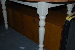 A vintage Schreiber low sideboard having opening cupboard doors flanking three drawers to centre