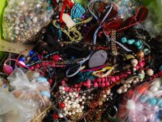 A large box of assorted costume jewellery to include silver charm bracelet, many necklaces, bangles,