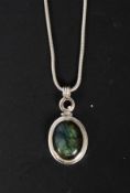 A ladies silver 925 and labradorite pendant and chain. The cabochon cut stone set to oval mount.