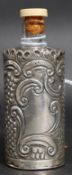 A silver overlaid perfume bottle having