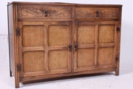 A 1930's oak Jacobean revival sideboard
