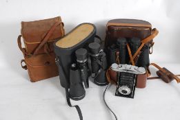 2 cased binocular sets together with an