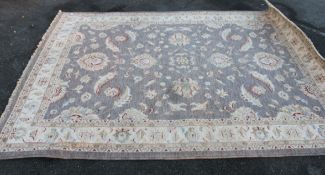 A large Afghan style rug with cream grou