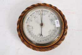 A vintage carved oak cased circular baro