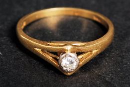 An 18k yellow gold single stone diamond,