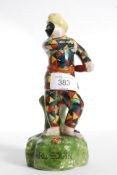 A Staffordshire figure of Harlequin rais