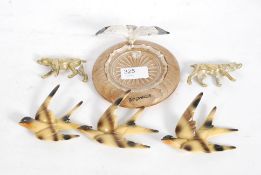 An unusual set of 3 metal birds being wa