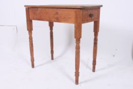 A pine table on turned legs having singl
