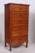 A French fruitwood upright chest of draw