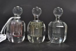 A set of three glass perfume bottles