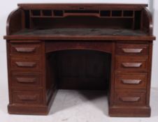 A large 1920's oak roll top tambour top