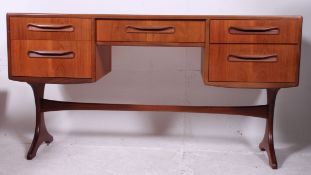 A 1970's G-Plan teak kneehole writing ta
