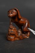 A carved wooden Japanese netsuke in the