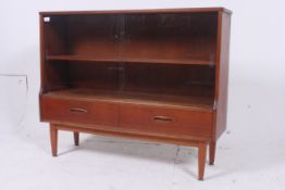 A retro Teak bookcase having glass slidi