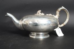 A large silver plated embossed teapot