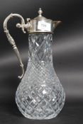 A silver plated and cut glass claret jug