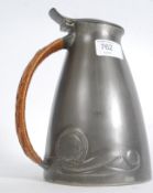 An English pewter hot water jug with bas