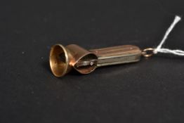 A yellow metal unmarked cigar cutter (be