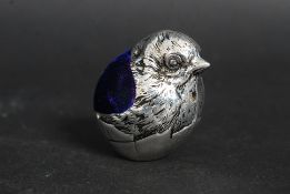 A silver plated pin cushion in the shape