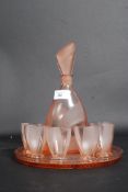 An art deco pink glass decanter along wi
