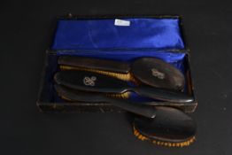 A set of early 20th century clothes brus