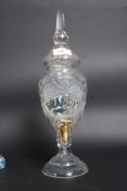 A cut glass brandy dispenser with brass