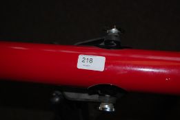 A Tasco telescope on tripod base.