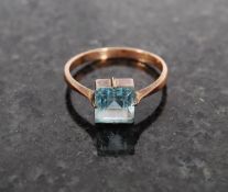 A 9ct gold ladies blue topaz ring being