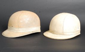 Two vintage leather motorcycle helmets