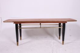 A retro teak and ebonised leg rectangula