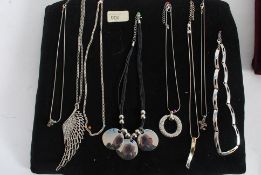 A collection of 8x necklaces some white