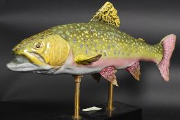 A large ceramic rainbow trout on a stand