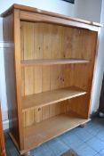 A contemporary pine bookcase having adju