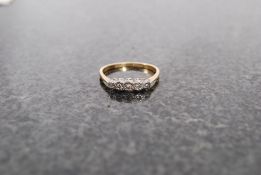 An 18ct gold and platinum ladies 5 stone