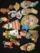 A collection of pottery wall masks to in