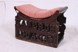 A 20th century carved wood stool with Ku