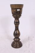 An early 20th century brass pedestal pla