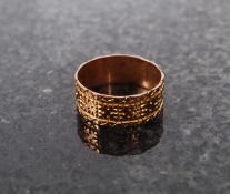 A 9ct gold  band ring being chase decora