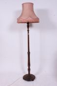 A 1930's mahogany standard lamp raised o