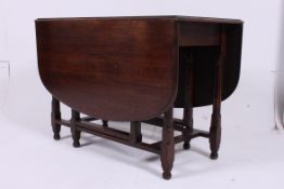 A 20th century oak drop leaf dining tabl
