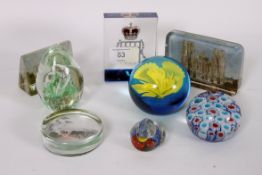 A collection of paperweights to include
