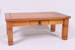 A 20th century low pine coffee table of