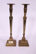 A pair of large brass candlesticks in th