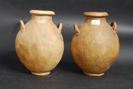 A pair of camel-skin vases / water carri