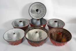 A collection of enamel painted metal con