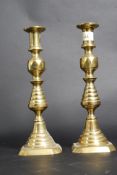 A pair of late 19th century brass candle