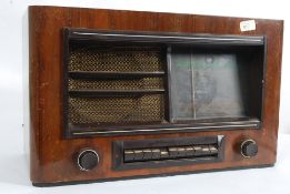 A vintage valve radio in oak case by KB.