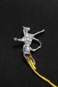 A white metal silver brooch in the form