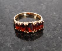 A 14ct gold ruby garnet 5 stone ring bei
