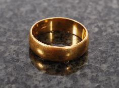 A 22ct gold  band ring being hallmarked